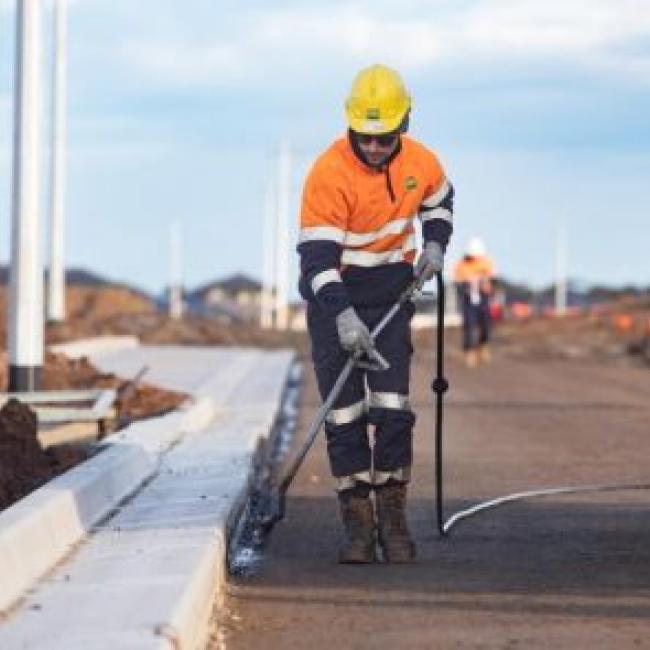 worker cleaning curb