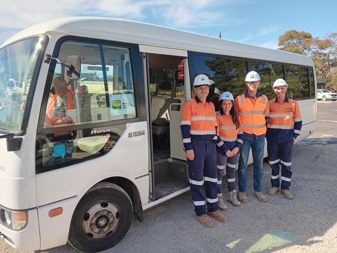 Montrose Quarry staff standing in front of the visiting tour bus