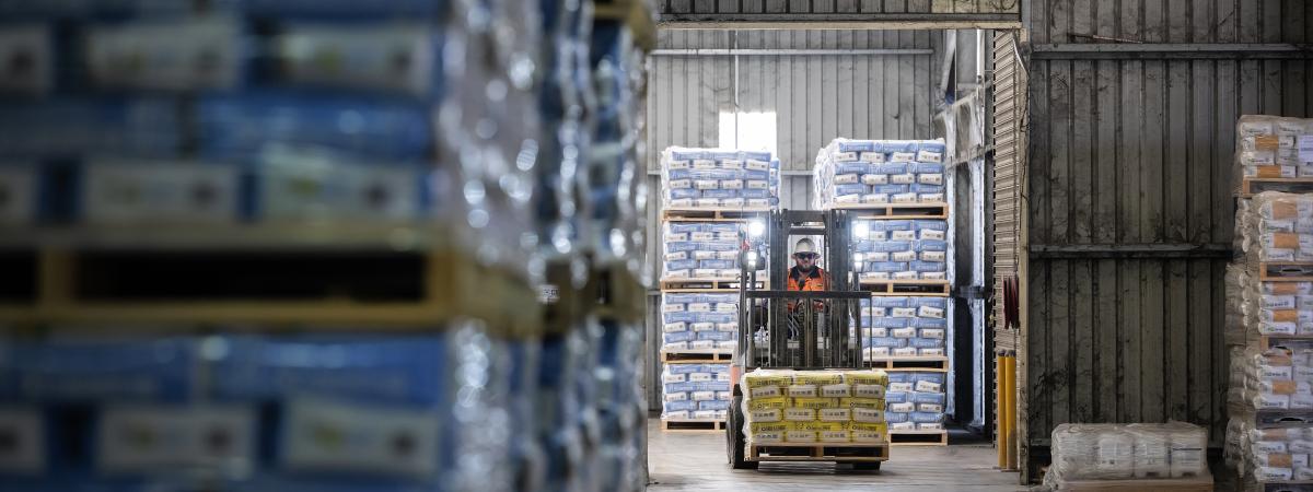 Forklift and piles of products in warehouse