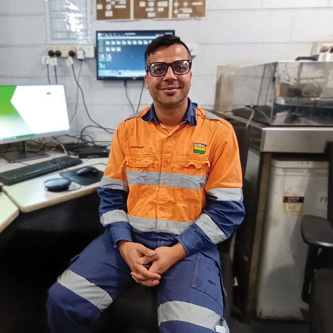 Raju Adhikari sitting at his desk