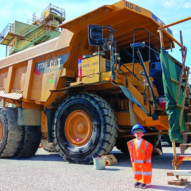 Reggie in PPE in front of Heavy Vehicle