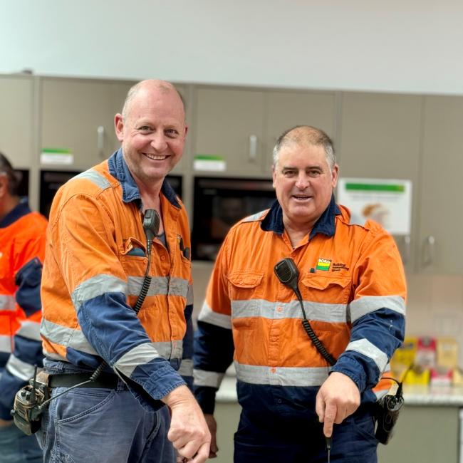Geoff Smith and Darren Tickner cutting cakes at Berrima