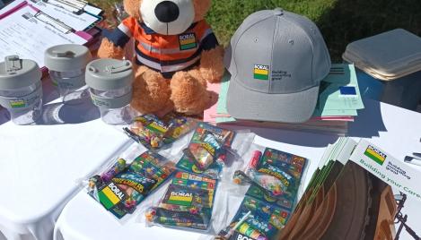 Boral merchandise on a table with a teddy bear in PPE