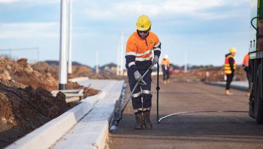 worker cleaning curb