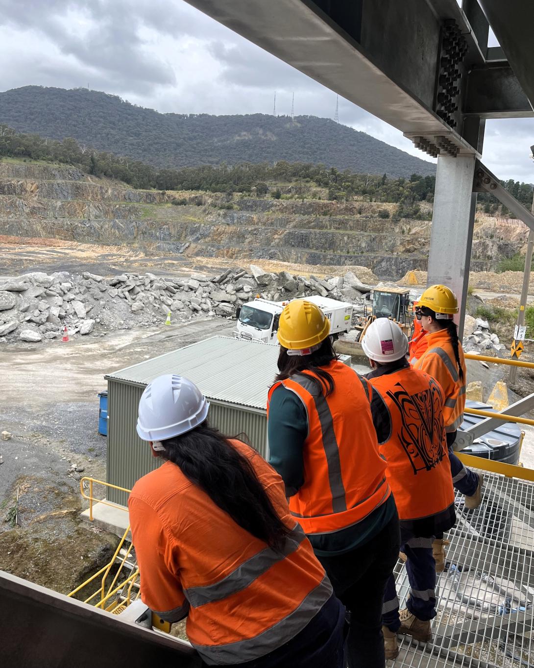 Women on platform looking out at quarry