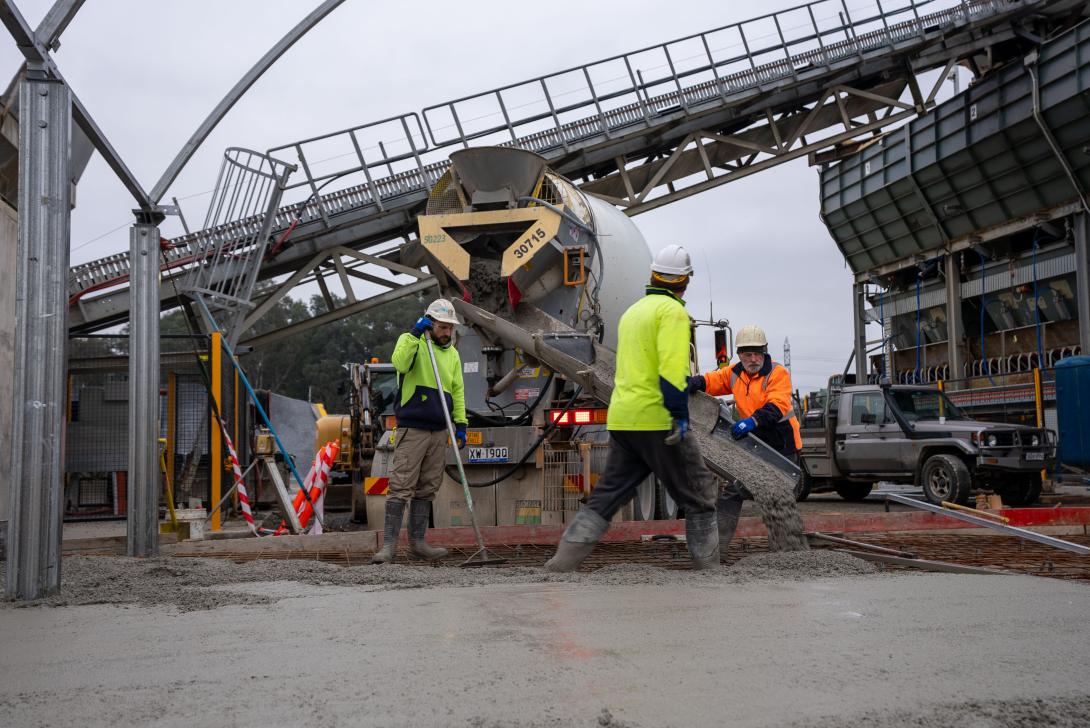 Workers spreading concrete