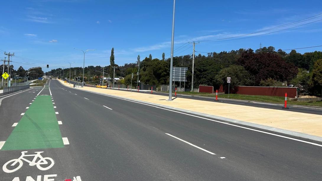 close up of highway with yellow coloured concrete island in centre
